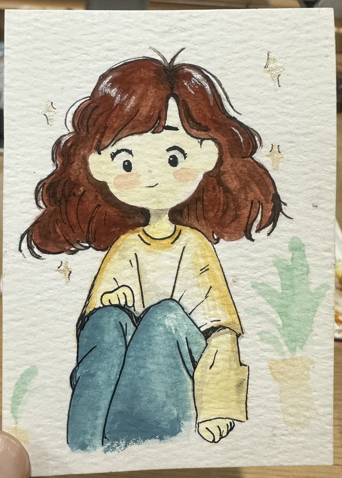 Original ACEO watercolor and gouache painting of a girl in a yellow sweater hugging her knees