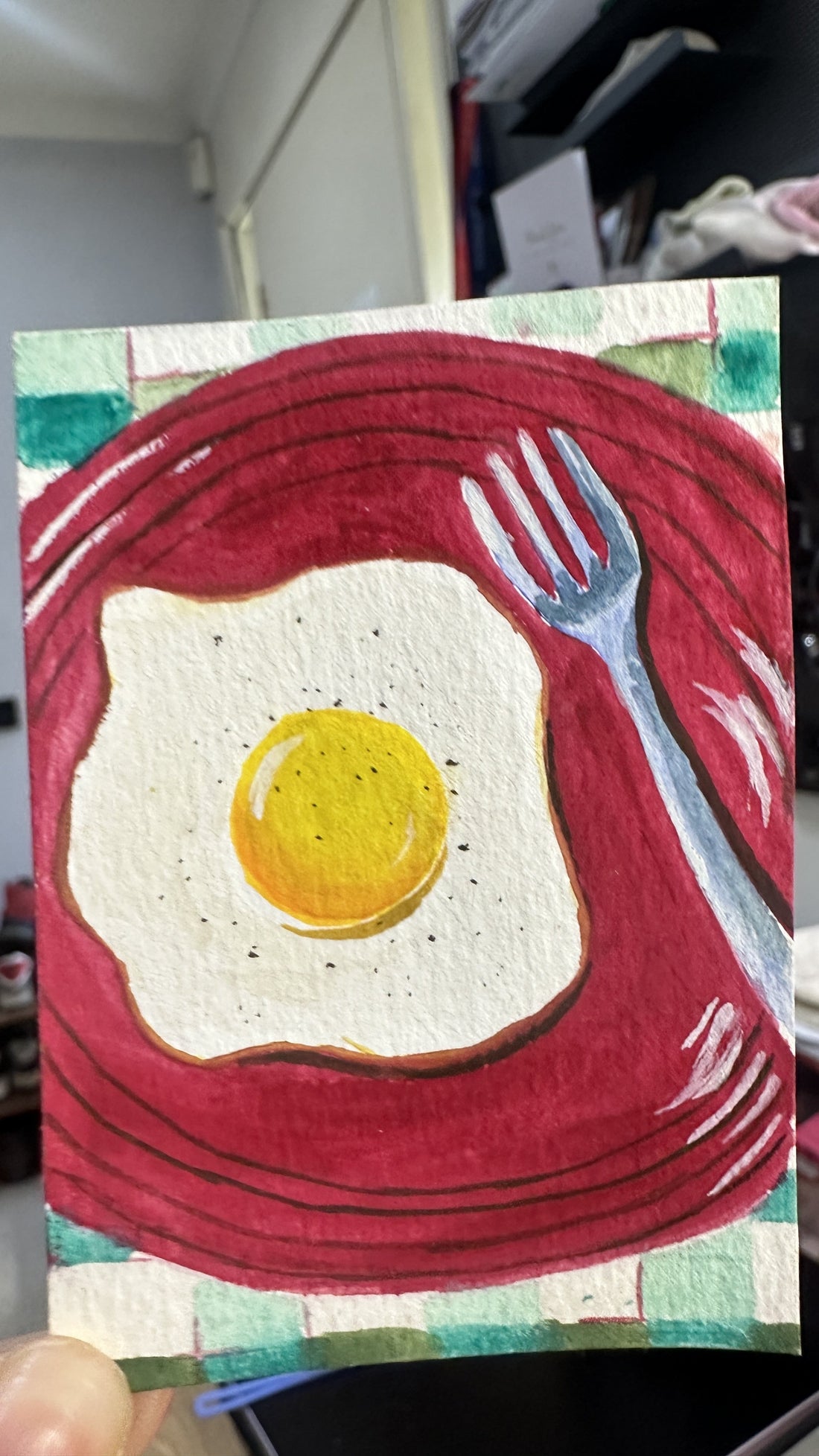 Original ACEO watercolor and gouache painting of a fried egg on a red plate with a fork