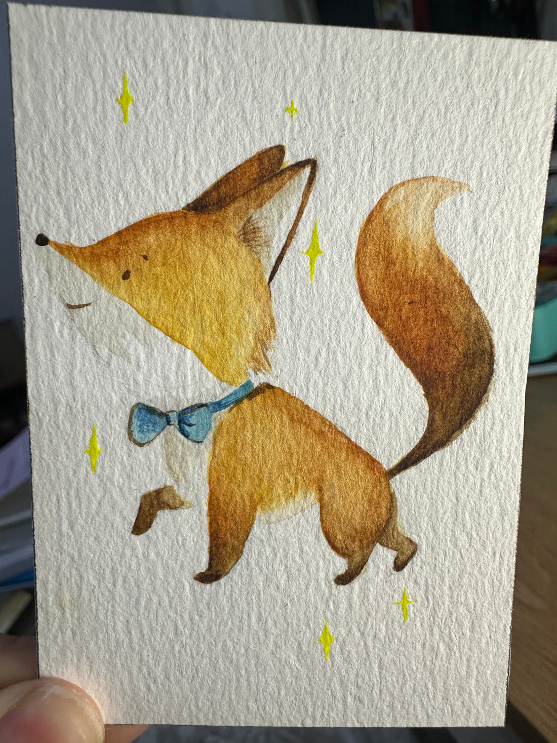 Original ACEO watercolor and gouache painting of a fox wearing a blue bow tie, walking among golden sparkles