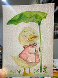 Original ACEO watercolor and gouache painting of a duckling wearing a pink raincoat and holding a leaf umbrella
