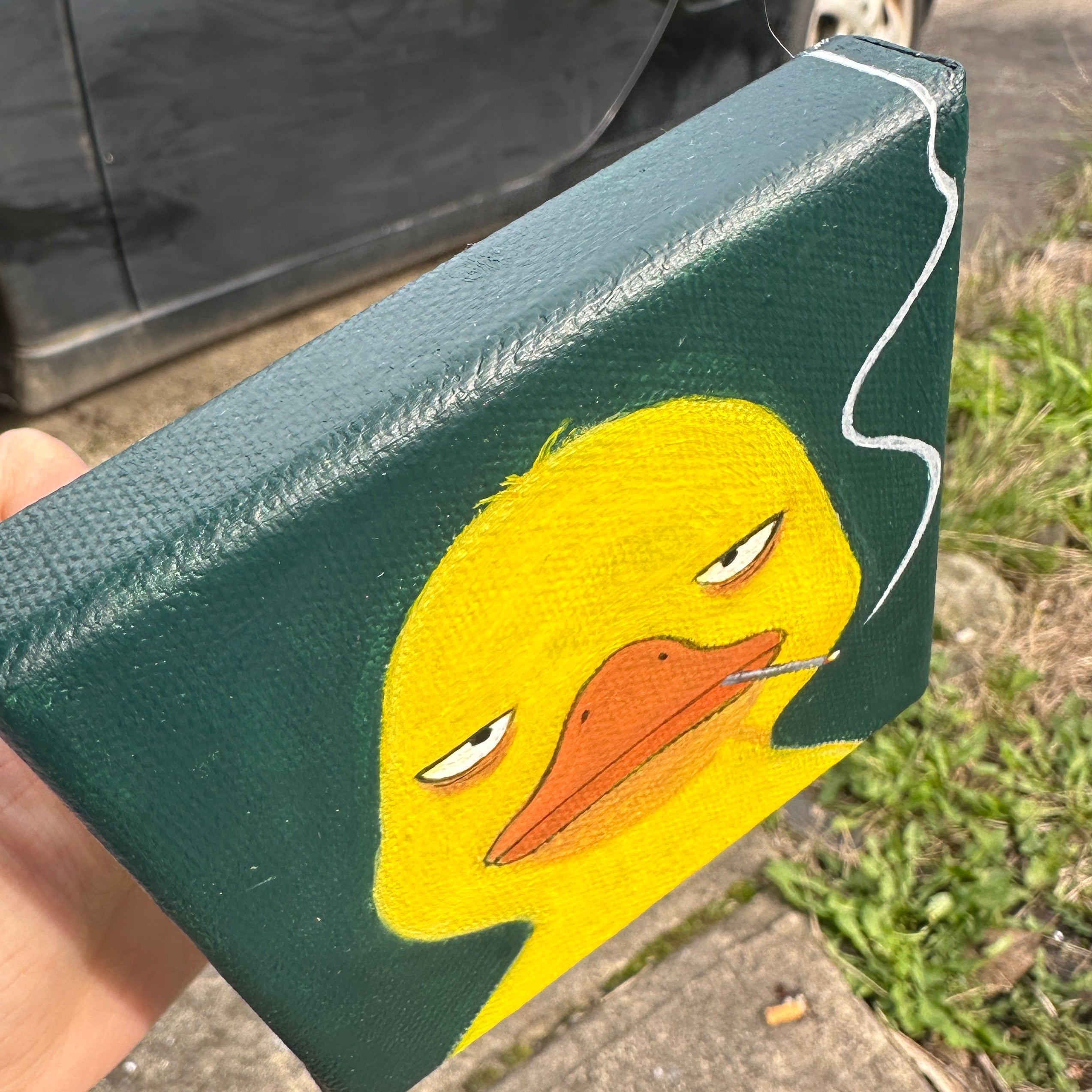 Side angle view of the duck with cigarette canvas painting showing canvas edge